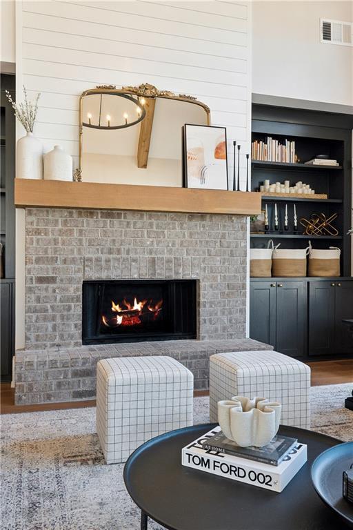 interior space with built in features, hardwood / wood-style floors, and a fireplace