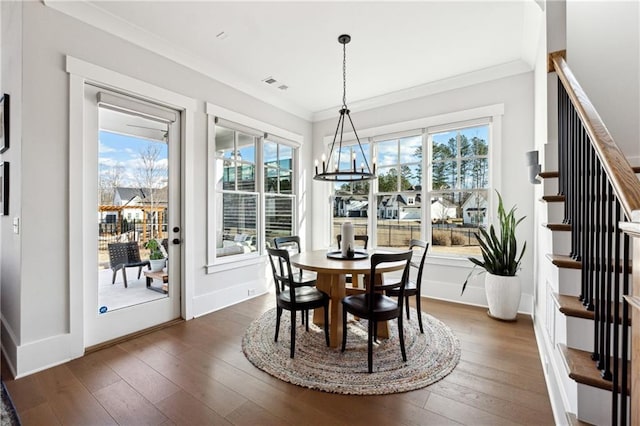 dining area featuring a notable chandelier, crown molding, and dark hardwood / wood-style flooring