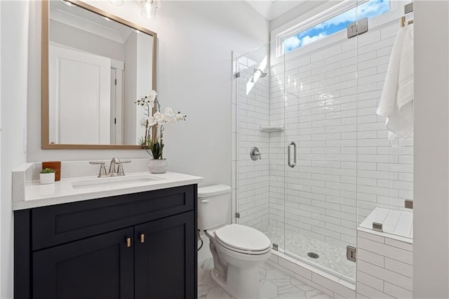 bathroom with a shower with shower door, toilet, and vanity