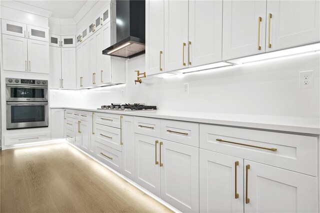 5175 Cascade Rd, Atlanta, GA 30331 - kitchen with wall chimney range hood, stainless steel appliances, white cabinets, and light countertops
