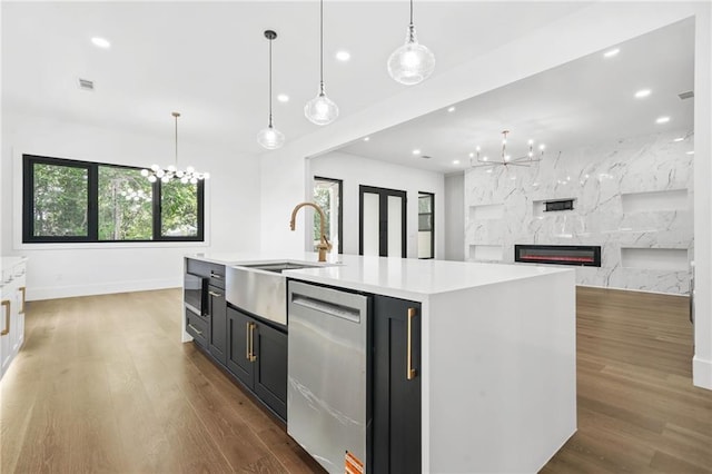 5175 Cascade Rd, Atlanta, GA 30331 - kitchen with a chandelier, stainless steel dishwasher, a sink, light countertops, and dark wood-type flooring