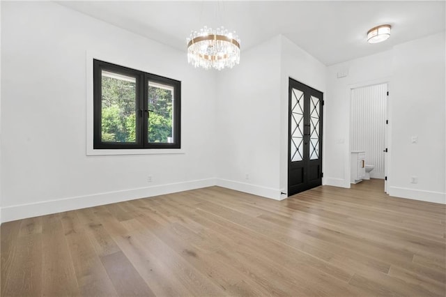 5175 Cascade Rd, Atlanta, GA 30331 - empty room featuring light wood finished floors, baseboards, and a chandelier