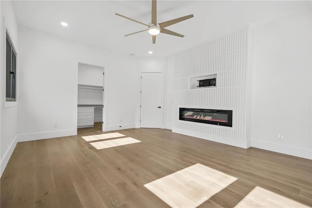 5175 Cascade Rd, Atlanta, GA 30331 - unfurnished living room featuring ceiling fan, baseboards, wood finished floors, recessed lighting, and a glass covered fireplace