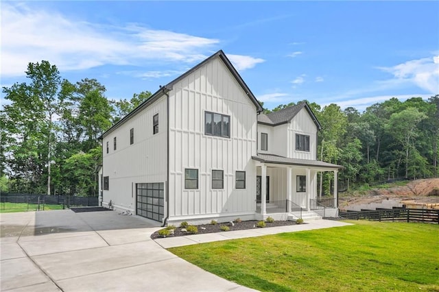 5175 Cascade Rd, Atlanta, GA 30331 - modern farmhouse with board and batten siding, covered porch, driveway, and a garage