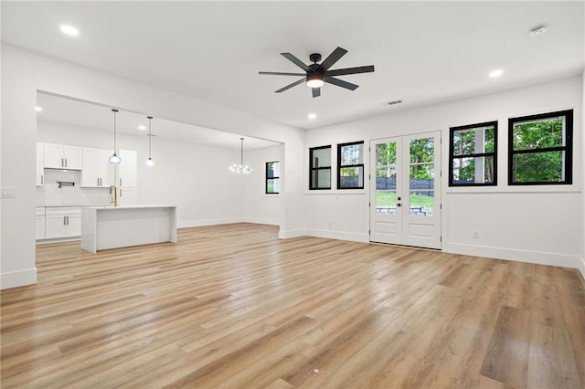 5175 Cascade Rd, Atlanta, GA 30331 - unfurnished living room with a chandelier, a ceiling fan, recessed lighting, light wood-type flooring, and baseboards