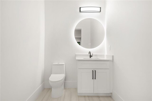 5175 Cascade Rd, Atlanta, GA 30331 - half bathroom featuring toilet, baseboards, and vanity
