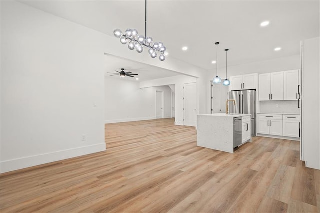 5175 Cascade Rd, Atlanta, GA 30331 - kitchen with appliances with stainless steel finishes, open floor plan, light countertops, light wood-style flooring, and white cabinets