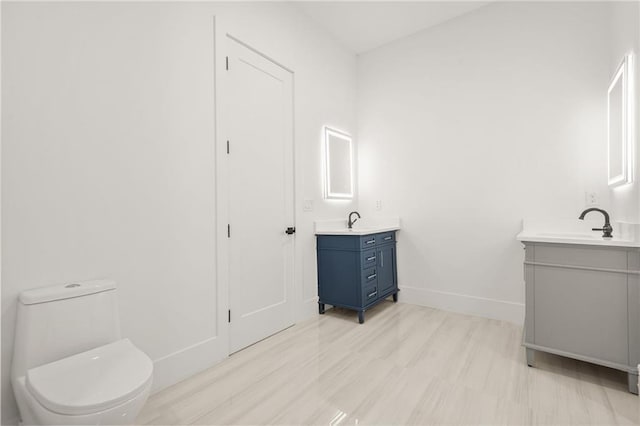 5175 Cascade Rd, Atlanta, GA 30331 - bathroom with two vanities, baseboards, and toilet