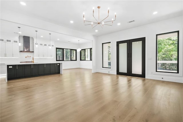 5175 Cascade Rd, Atlanta, GA 30331 - unfurnished living room with recessed lighting, plenty of natural light, light wood-style floors, a chandelier, and baseboards