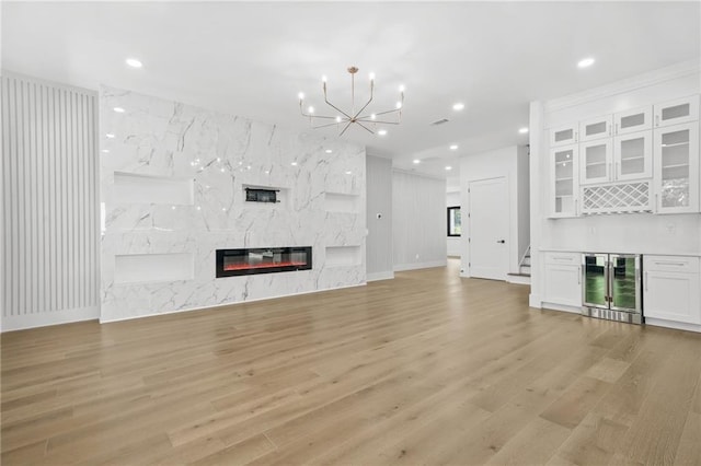5175 Cascade Rd, Atlanta, GA 30331 - unfurnished living room with beverage cooler, a dry bar, light wood finished floors, a chandelier, and recessed lighting