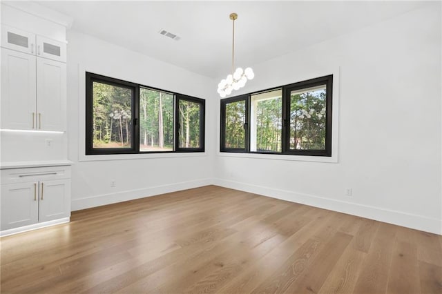 5175 Cascade Rd, Atlanta, GA 30331 - unfurnished dining area with healthy amount of natural light, light wood-type flooring, baseboards, and a chandelier