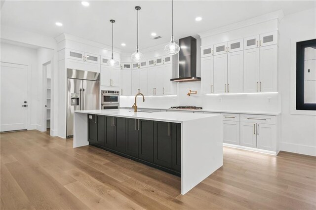 5175 Cascade Rd, Atlanta, GA 30331 - kitchen featuring wall chimney range hood, stainless steel appliances, a sink, light countertops, and white cabinetry