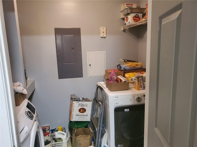 laundry room with electric panel and separate washer and dryer