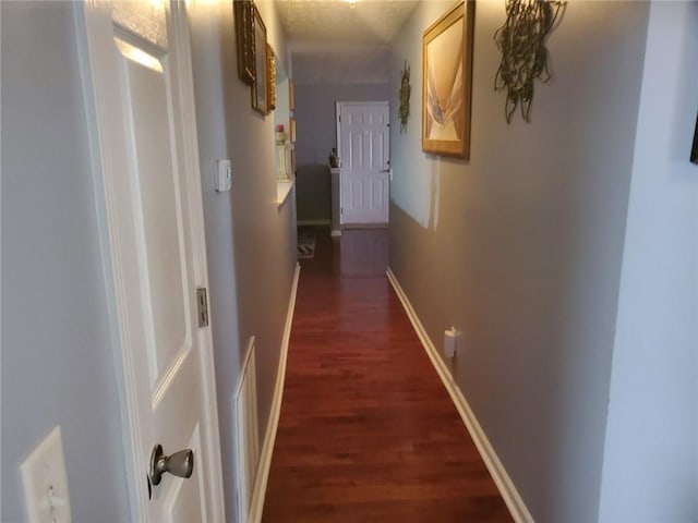 corridor featuring dark wood-type flooring