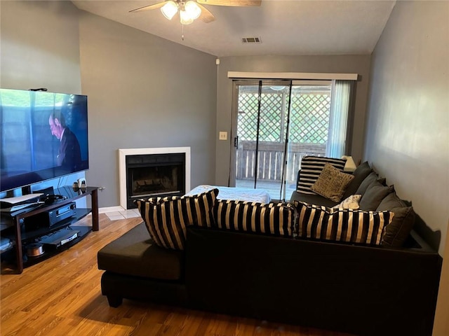 living room featuring hardwood / wood-style floors and ceiling fan