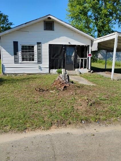 1111 Hartley St, Macon, GA 31206 - rear view of house with a sunroom, a lawn, and a detached carport