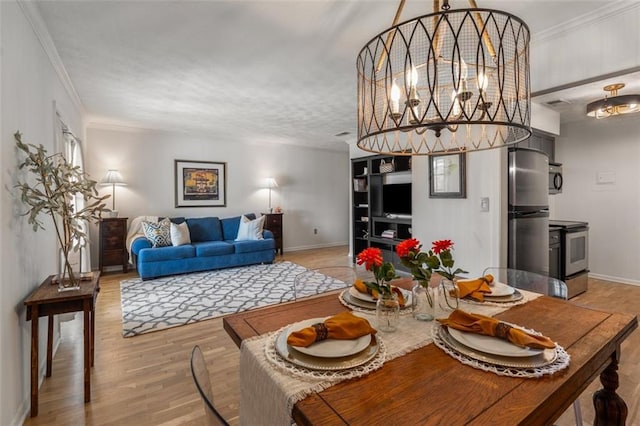 dining space featuring light hardwood / wood-style flooring, crown molding, and a notable chandelier