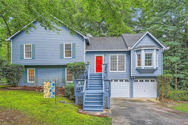 view of front of house with a garage, asphalt driveway, and a front yard