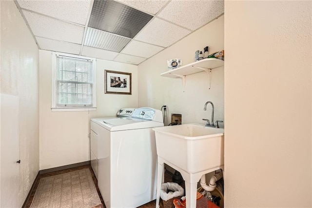laundry room featuring washing machine and dryer and baseboards