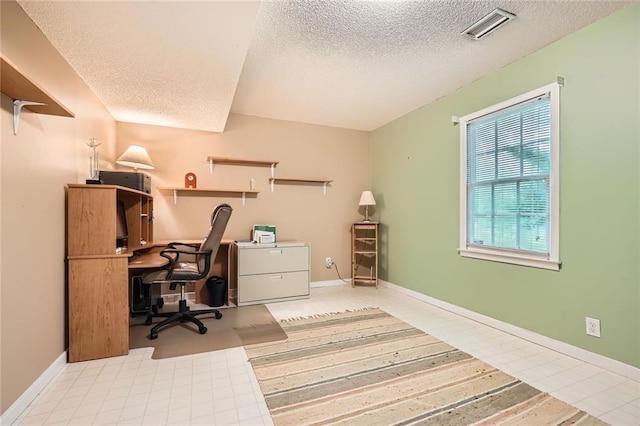 office space featuring a textured ceiling and baseboards
