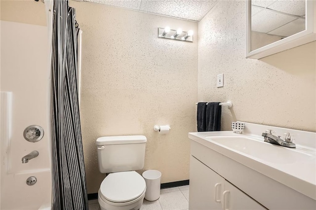 bathroom with shower / bathtub combination with curtain, toilet, vanity, tile patterned flooring, and baseboards