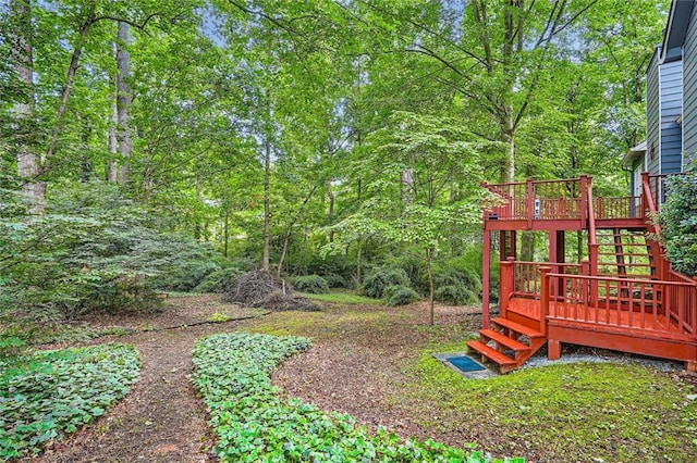 view of yard with stairway and a deck