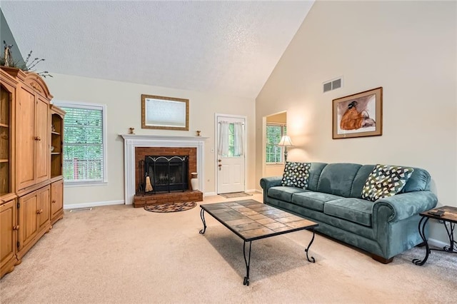 living room with light colored carpet, a textured ceiling, baseboards, a brick fireplace, and high vaulted ceiling