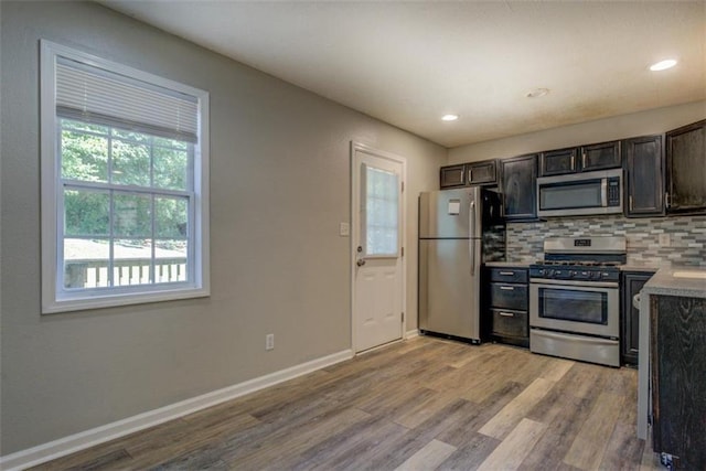 302 Atlanta Ave, Atlanta, GA 30315 - kitchen with appliances with stainless steel finishes, light wood-type flooring, decorative backsplash, baseboards, and recessed lighting