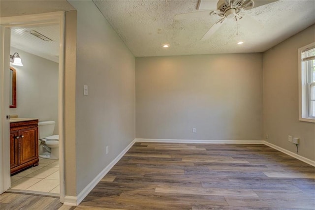 302 Atlanta Ave, Atlanta, GA 30315 - empty room with light wood finished floors, ceiling fan, a textured ceiling, and baseboards