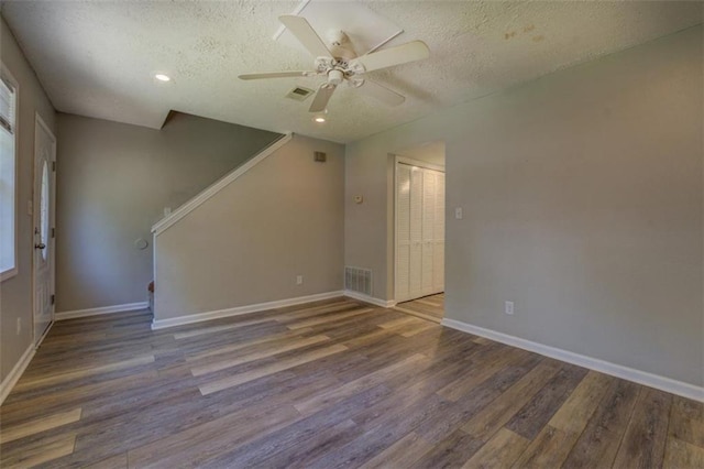 302 Atlanta Ave, Atlanta, GA 30315 - empty room featuring wood finished floors, a textured ceiling, stairs, ceiling fan, and baseboards