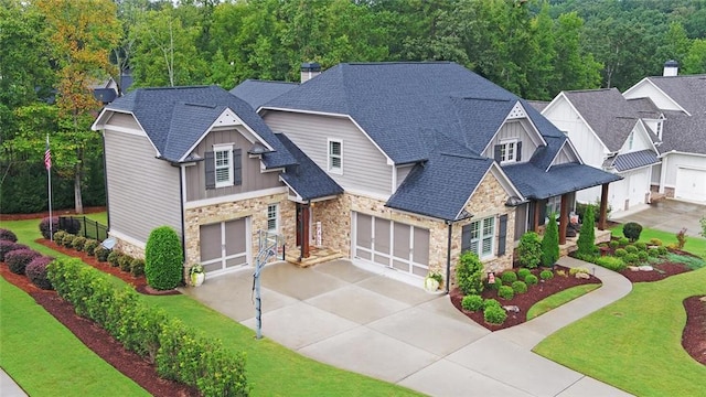 view of front of home featuring a front yard and a garage