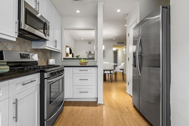 kitchen featuring decorative backsplash, light hardwood / wood-style flooring, stainless steel appliances, and white cabinets