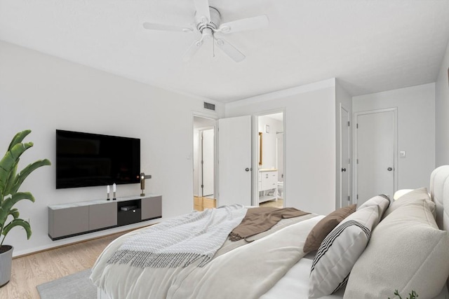 bedroom with ensuite bath, ceiling fan, and light wood-type flooring