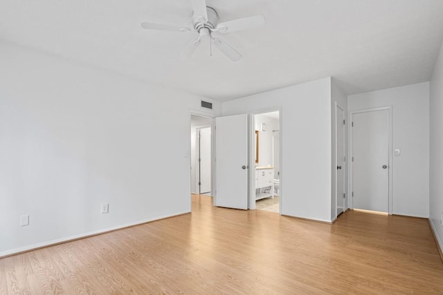 unfurnished bedroom with ceiling fan, ensuite bath, and light hardwood / wood-style flooring