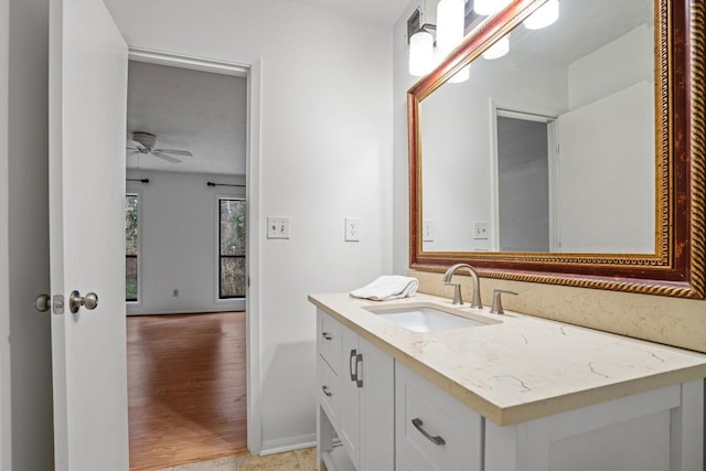 bathroom featuring ceiling fan, vanity, and wood-type flooring