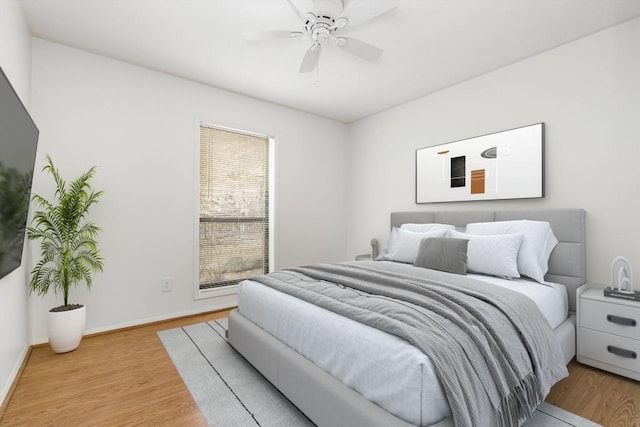 bedroom with light hardwood / wood-style floors and ceiling fan