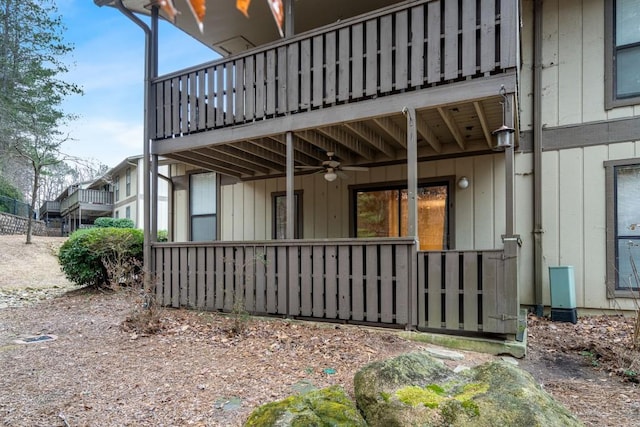 view of side of home featuring ceiling fan and a balcony