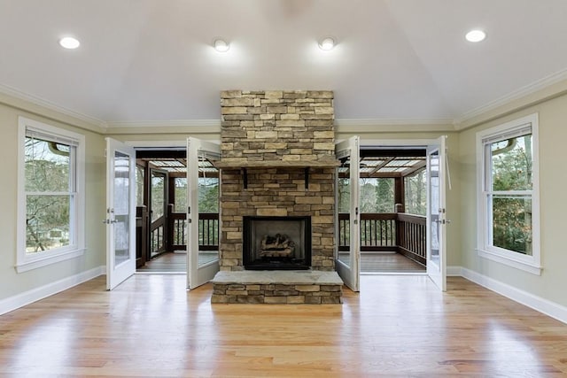 unfurnished living room with crown molding, light hardwood / wood-style floors, and a fireplace