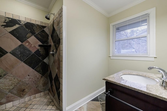 bathroom featuring a tile shower, ornamental molding, and vanity