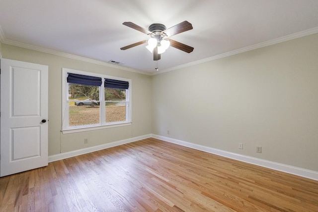 spare room with light hardwood / wood-style floors, ornamental molding, and ceiling fan