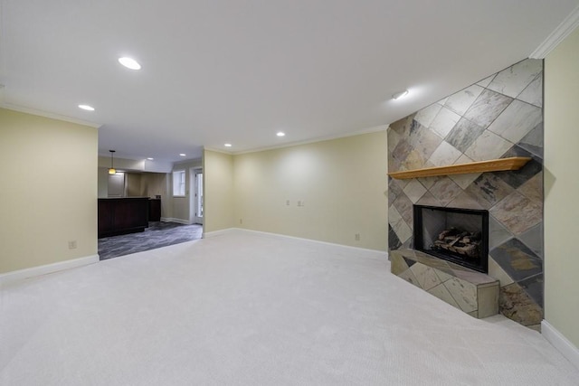 unfurnished living room with carpet, crown molding, and a fireplace