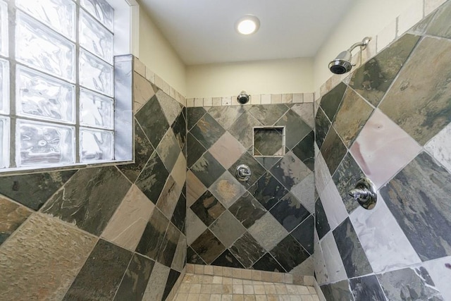 bathroom featuring a tile shower