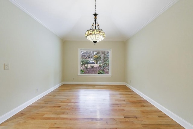 empty room featuring light hardwood / wood-style flooring and crown molding