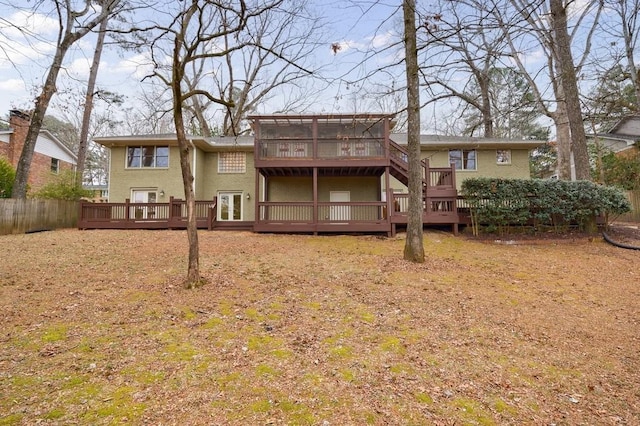 rear view of property with a wooden deck and a sunroom