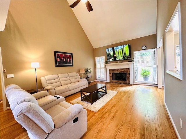 1739 Praters Pt, Dacula, GA 30019 - living room with high vaulted ceiling, healthy amount of natural light, wood finished floors, a fireplace, and a ceiling fan