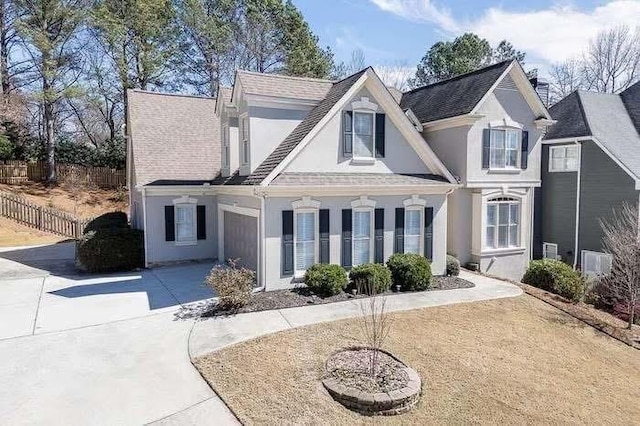 1739 Praters Pt, Dacula, GA 30019 - back of house with stucco siding, driveway, and fence