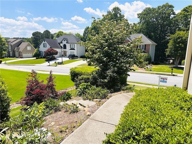 1739 Praters Pt, Dacula, GA 30019 - view of green lawn featuring a residential view and concrete driveway