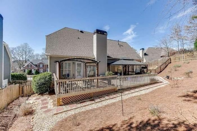 1739 Praters Pt, Dacula, GA 30019 - rear view of house with a gazebo, a fenced backyard, a chimney, and a deck