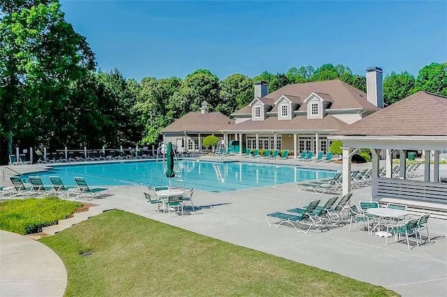 1739 Praters Pt, Dacula, GA 30019 - community pool with a patio and view of scattered trees