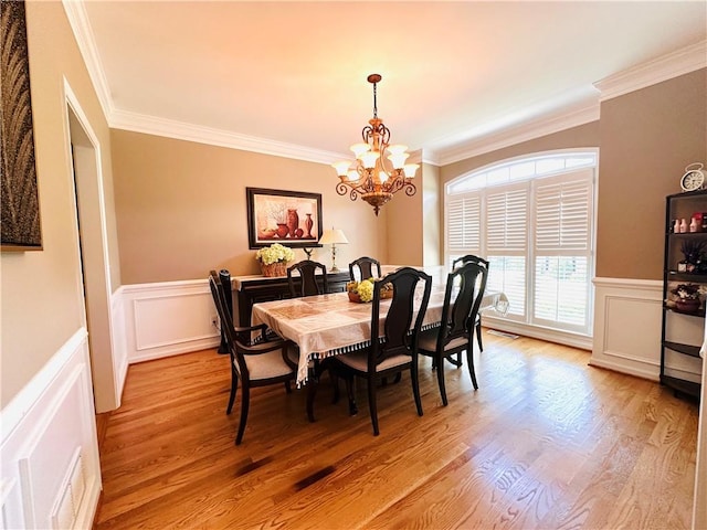 1739 Praters Pt, Dacula, GA 30019 - dining area featuring ornamental molding, a chandelier, light wood-type flooring, a wainscoted wall, and a decorative wall